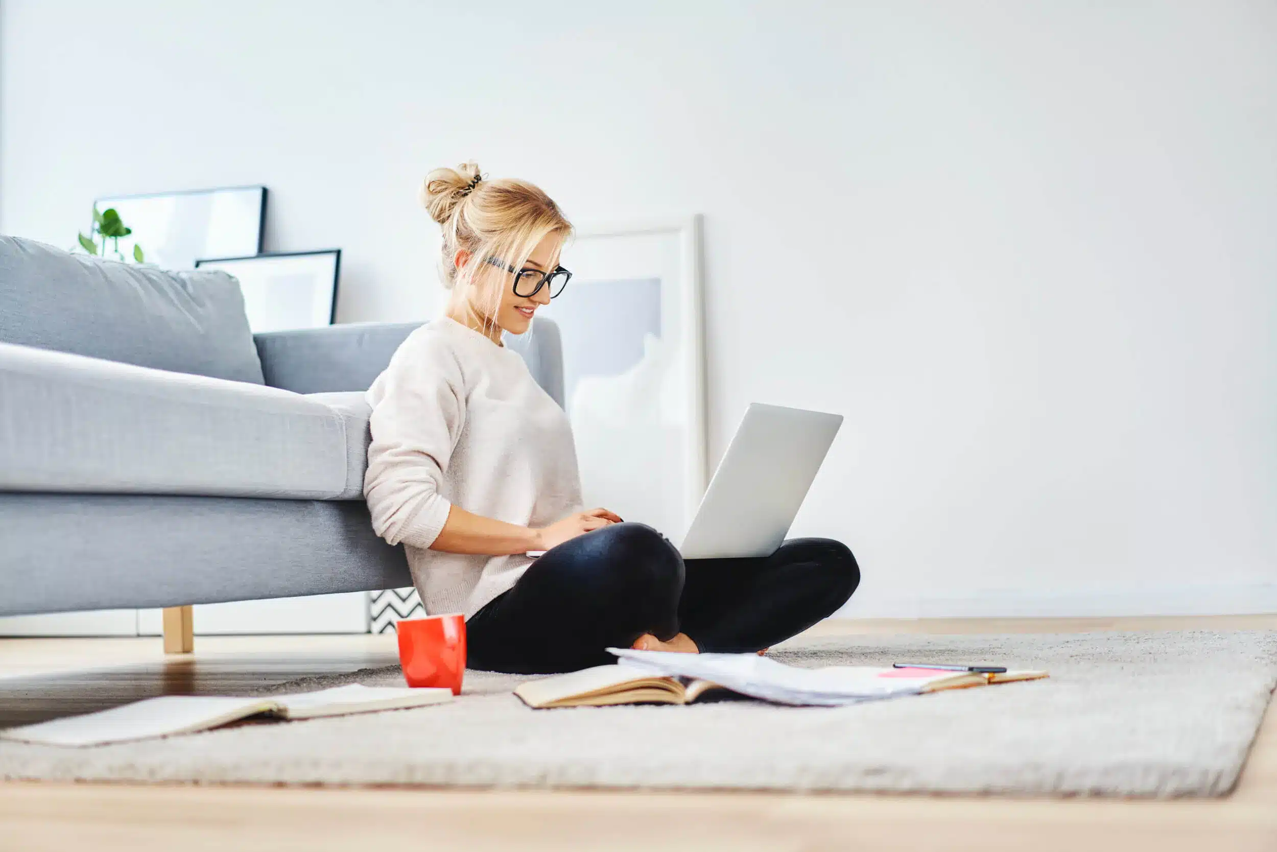 woman sitting on floor focusing on laptop 1